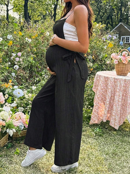 Black Solid Spaghetti Strap Maternity Jumpsuit – Loose Fit Side Knot Sleeveless Romper for Beach, Casual Everyday & Summer Travel