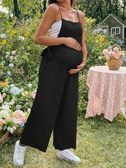 Black Solid Spaghetti Strap Maternity Jumpsuit – Loose Fit Side Knot Sleeveless Romper for Beach, Casual Everyday & Summer Travel