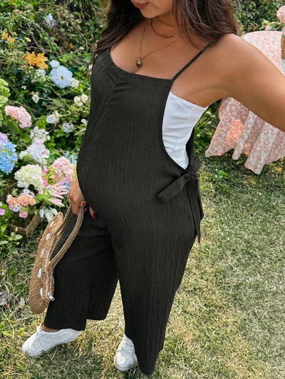 Black Solid Spaghetti Strap Maternity Jumpsuit – Loose Fit Side Knot Sleeveless Romper for Beach, Casual Everyday & Summer Travel